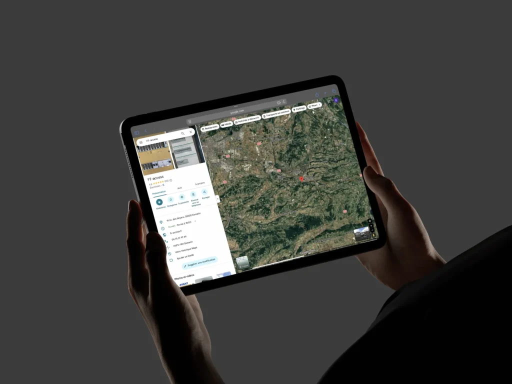 Une personne tient une tablette affichant une carte et des informations sur un lieu.